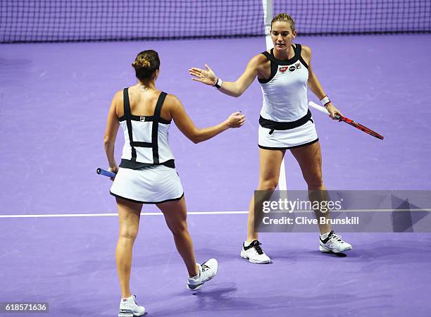 Timea Babos of Hungary and Yaroslava Shvedova of Kazakhstan celebrate in their doubles match against Bethanie Mattek-Sands of the United States and...