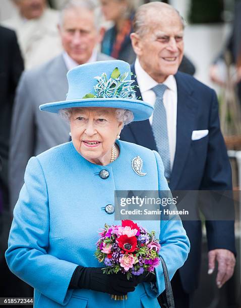 Queen Elizabeth II and Prince Philip, Duke of Edinburgh tour Queen Mother Square on October 27, 2016 in Poundbury, Dorset.