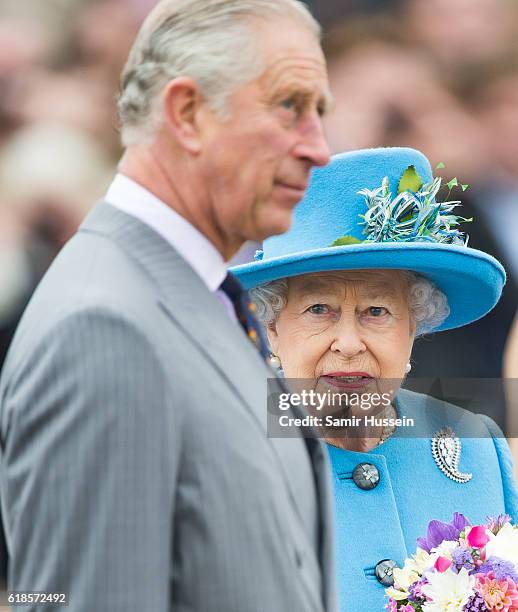 Prince Charles, Prince of Wales and Queen Elizabeth II tour Queen Mother Square on October 27, 2016 in Poundbury, Dorset.