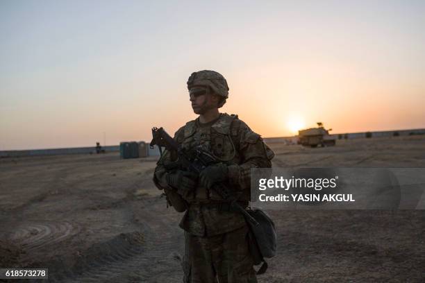 Photo taken on October 20, 2016 shows a US soldier standing at the Qayyarah military base during the ongoing operation to recapture the last major...