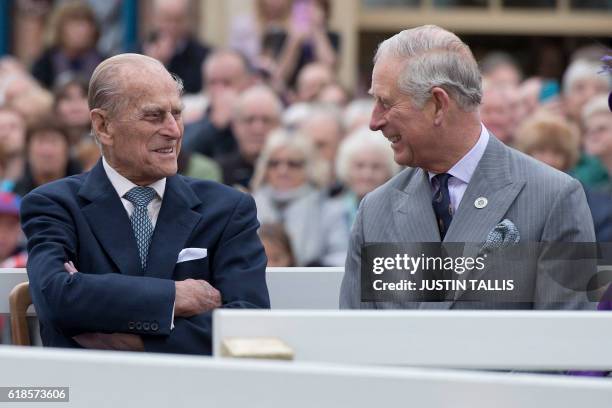 Britain's Prince Philip, Duke of Edinburgh and Prince Charles, Prince of Wales listen to speeches before a statue of the Queen Elizabeth The Queen...