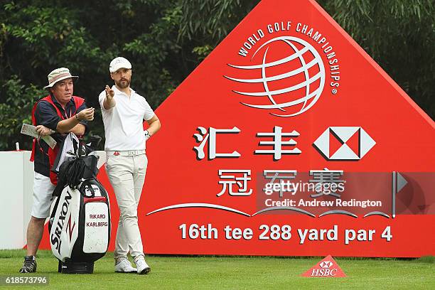 Rikard Karlberg of Sweden looks down the 16th hole with caddie Mick Donaghy during day one of the WGC - HSBC Champions at Sheshan International Golf...