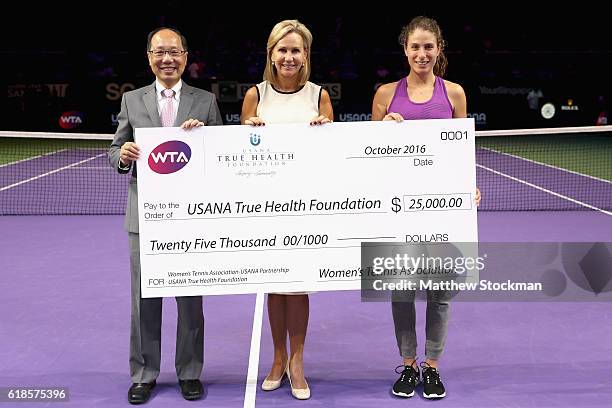 Ng Keng Hean of USANA, Micky Lawler, WTA President and Johanna Konta of Great Britain pose with a cheque during day 5 of the BNP Paribas WTA Finals...