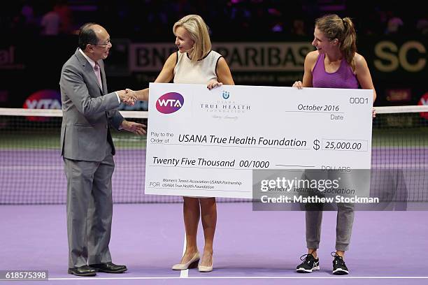 Ng Keng Hean of USANA, Micky Lawler, WTA President and Johanna Konta of Great Britain pose with a cheque during day 5 of the BNP Paribas WTA Finals...