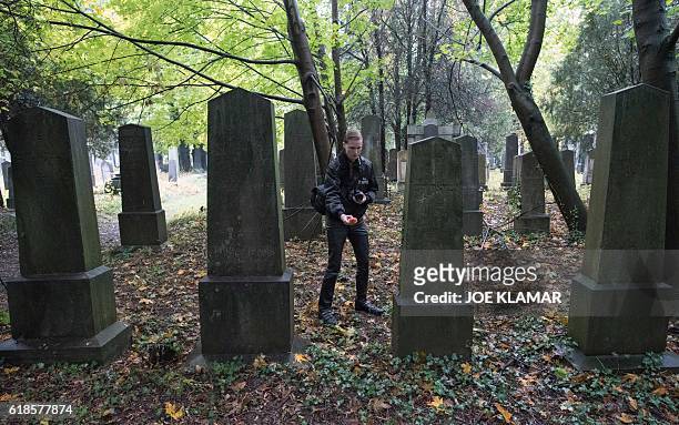"Paranormal Investigator" Dominik Creazzi from Vienna Ghosthunters looks for paranormal activity at Vienna Central Cemetery on October 20, 2016. The...