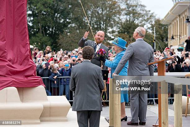 Britain's Queen Elizabeth II and Britain's Prince Charles, Prince of Wales unveil a statue of the Queen Elizabeth, The Queen Mother in the square on...