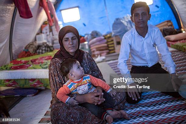 Family from the village of Tob Zawa, which was recently taken from ISIS, sit quietly in their tent in a recently opened camp for people who have been...