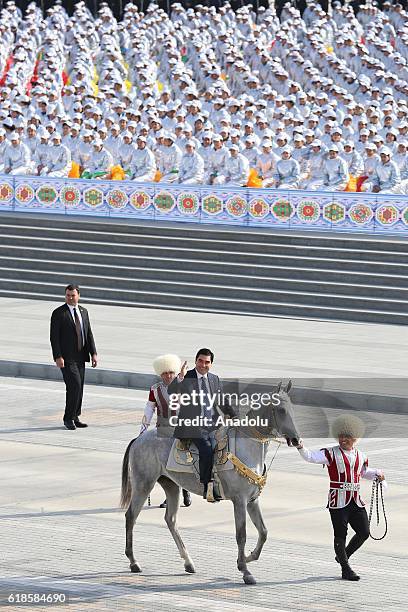 President of Turkmenistan Gurbanguly Berdimuhamedow greets people onto the horse during the official parade held for the 25th anniversary of...