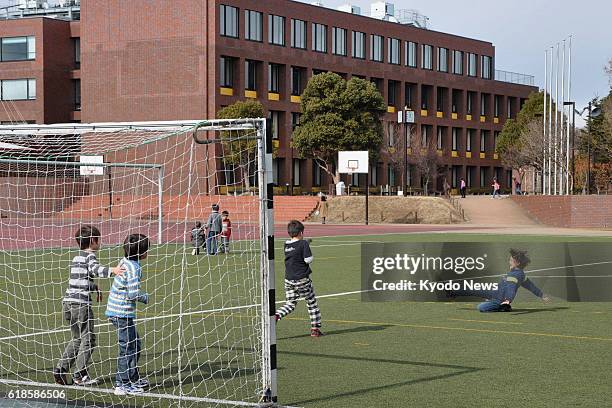 Yokohama, Japan - Children of the German School of Tokyo Yokohama play soccer at the schoolyard in Yokohama on Feb. 2, 2012. The institution, which...