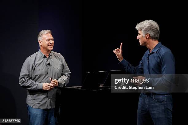 Apple Senior Vice President of Software Engineering Craig Federighi gestures to Vice President of Worldwide Marketing Phil Schiller during a product...