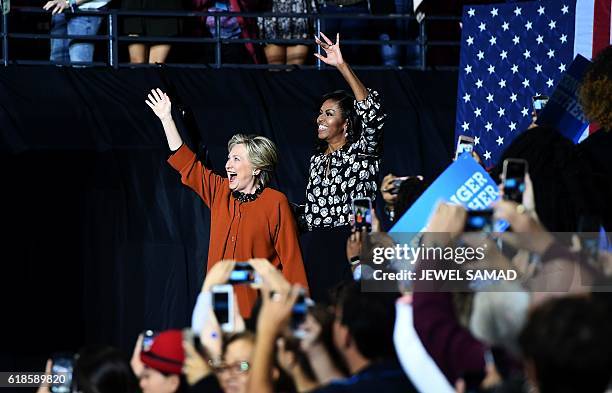 First Lady Michelle Obama and Democratic presidential nominee Hillary Clinton arrive on stage during a campaign rally in Winston-Salem, North...