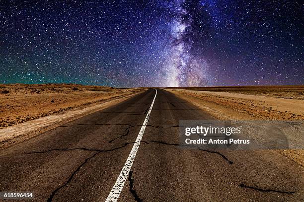 road in the desert at night with the milky way - rocky star stock pictures, royalty-free photos & images