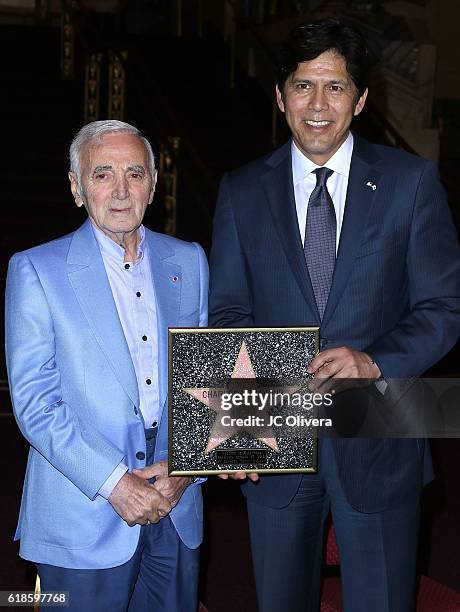 Charles Aznavour and Senator Kevin De Leon during an Award Ceremony where Mr Aznavour received a Honorary Walk Of Fame Plaque by Senator Kevin De...