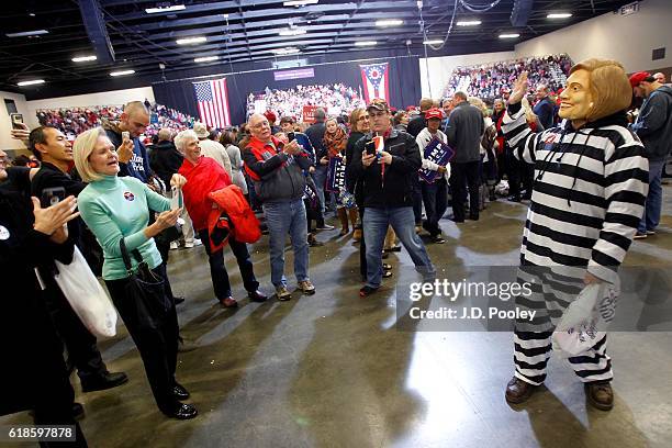 Aaron Stoianowski, dressed as Hillary Clinton, interacts with supporters of Republican presidential nominee Donald Trump during a campaign event at...