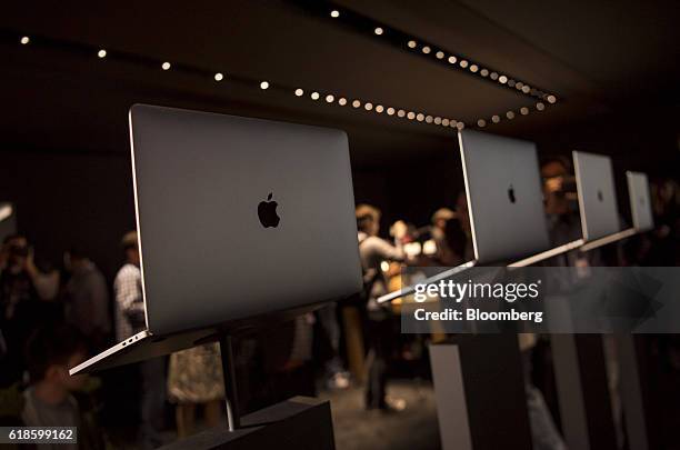 Attendees view new MacBook Pro laptop computers during an event at Apple Inc. Headquarters in Cupertino, California, U.S., on Thursday, Oct. 27,...