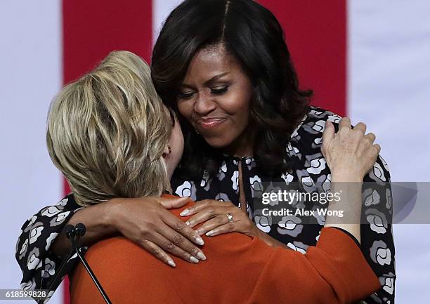 Democratic presidential candidate Hillary Clinton and U.S. First lady Michelle Obama embrace during a campaign event at the Lawrence Joel Veterans...