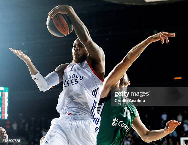 Deshuan Thomas of Anadolu Efes in action against Adrien Moerman of Darussafaka Dogus during the THY EuroLeauge Top 16 basketball match between...