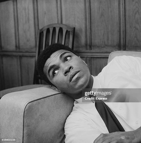 American boxer Muhammad Ali relaxes in his hotel room in London, the day after his victory over Henry Cooper at the Arsenal Stadium, UK, 22nd May...