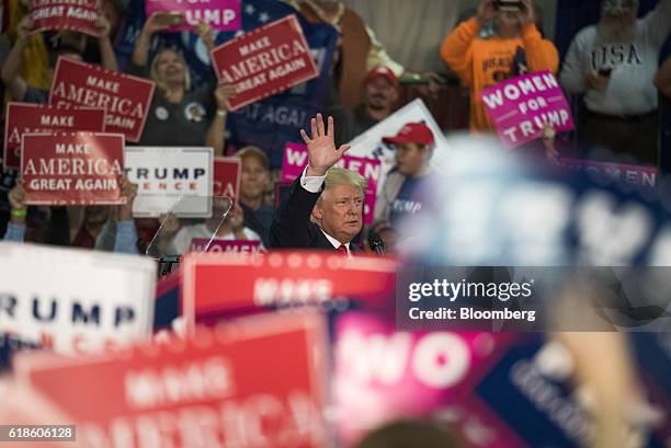 Donald Trump, 2016 Republican presidential nominee, waves to the crowd after speaking during a campaign event in Springfield, Ohio, U.S., on...