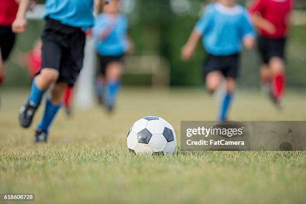 kicking the ball - shin guard stock pictures, royalty-free photos & images