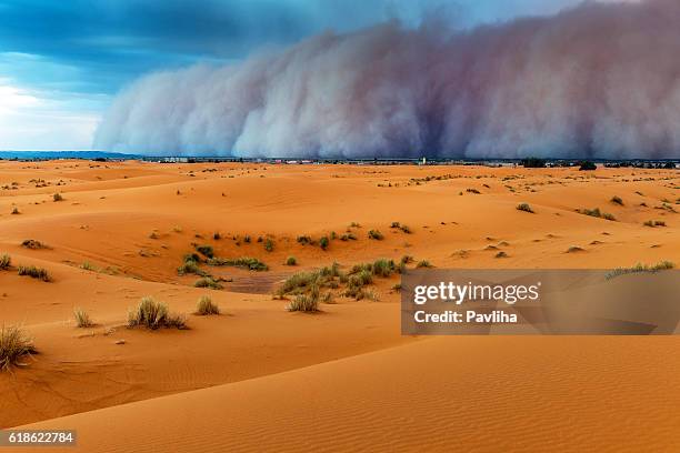 sandstorm approaching merzouga settlement,in erg chebbi desert morocco,africa - sand storm stock pictures, royalty-free photos & images