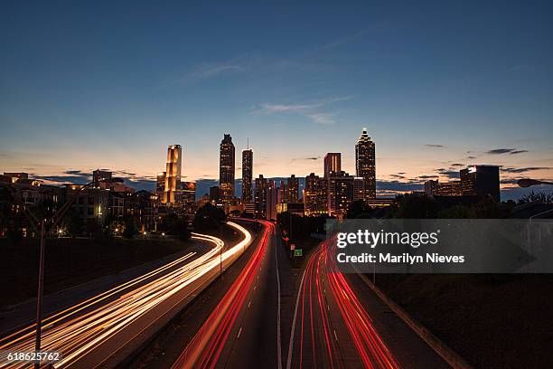 light streaks through the atlanta highways at blue hour - atlanta traffic stock pictures, royalty-free photos & images