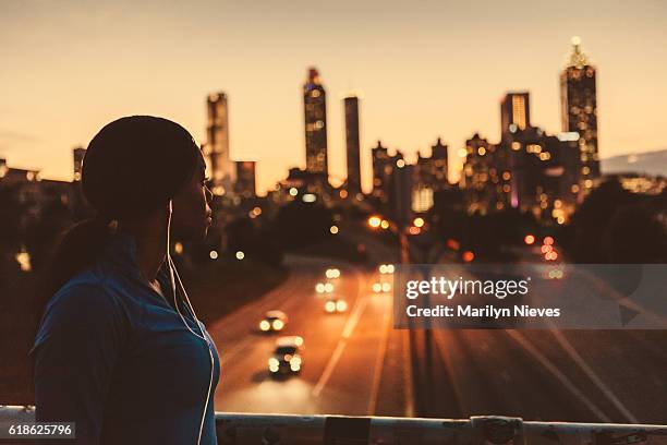 female runner looking out to the skyline - atlanta georgia stock pictures, royalty-free photos & images