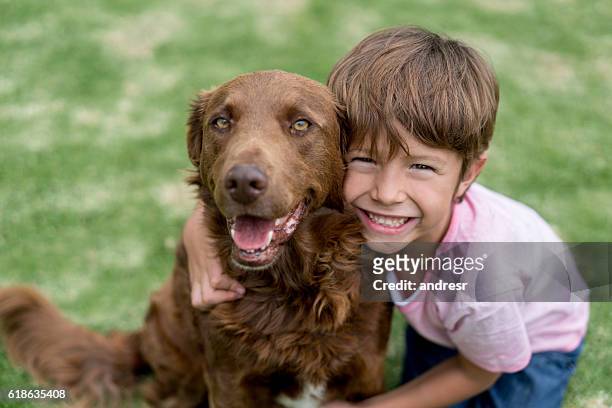 glücklicher junge mit seinem adoptierten hund - pet adoption stock-fotos und bilder
