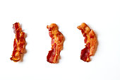 Three Slices of Bacon Isolated on a White Background