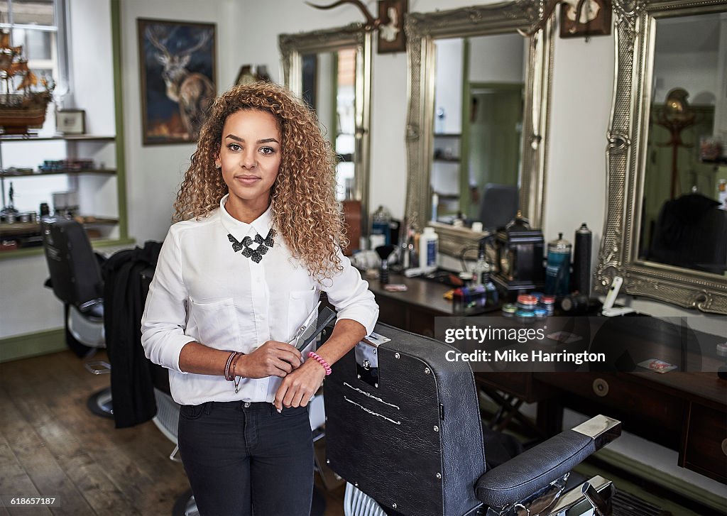 Portrait of young female barber