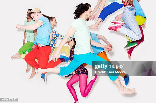 group of people jumping - bunte hose stock-fotos und bilder