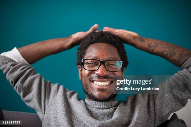 man laughing radiantly - arm tattoos for black men fotografías e imágenes de stock