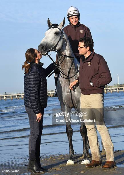 Trainer Matt Cumani and sister Francesca Cumani pose with Grey Lion with track rider Bastion Neuhaus after a trackwork session at Altona Beach ahead...