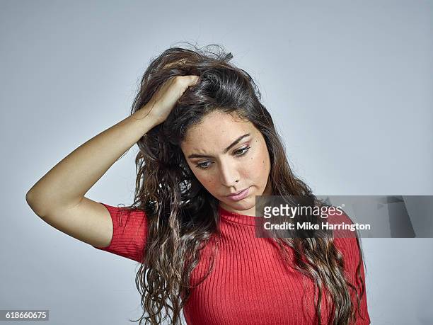 portrait of young brunette female holding hair - look down - fotografias e filmes do acervo