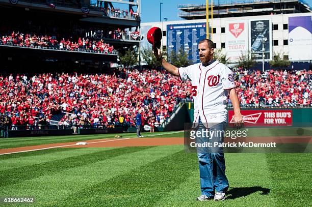 Former MLB player Adam LaRoche waves to the crowd after throwing out the ceremonial first pitch prior to game two of the National League Division...