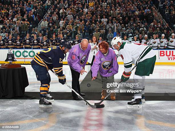 Roswell Park Cancer Institute patients Dan Zotara and Colleen Williams drop a ceremonial puck for a faceoff between Brian Gionta of the Buffalo...