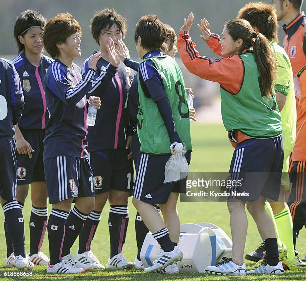 Portugal - FIFA Women's World Player of the Year Homare Sawa and her Japan teammates exchange high-fives after earning a come-from-behind 2-1 win...