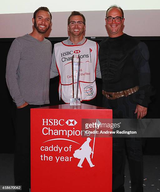 Austin Johnson is presented with his Caddy of the Year Award by HSBC's Giles Morgan and player/brother Dustin Johnson after the first round of the...
