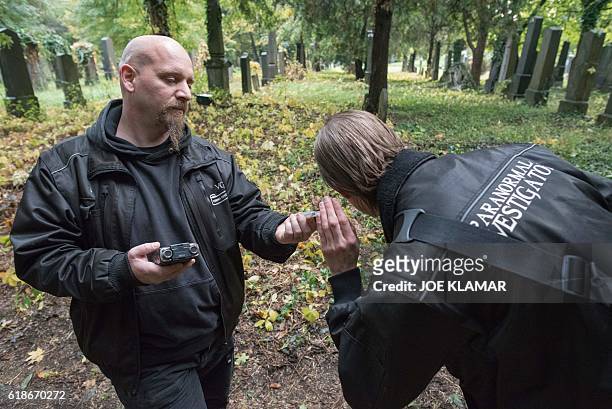 "Paranormal Investigators" Willi Gabler and Dominik Creazzi from Vienna Ghosthunters looks for paranormal activity at Vienna Central Cemetery on...