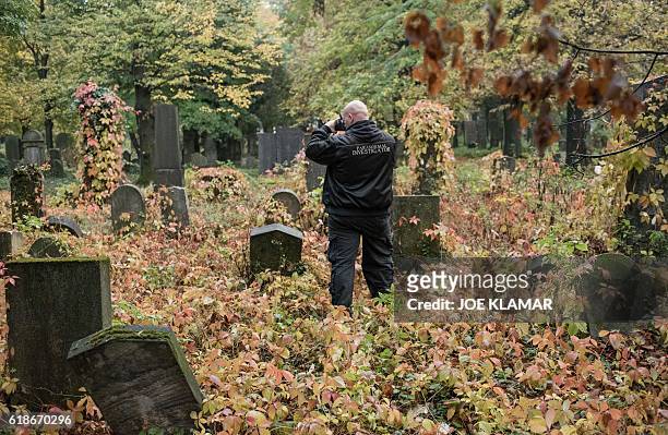 "Paranormal Investigator" Willi Gabler from Vienna Ghosthunters looks for paranormal activity at Vienna Central Cemetery on October 20, 2016. The...