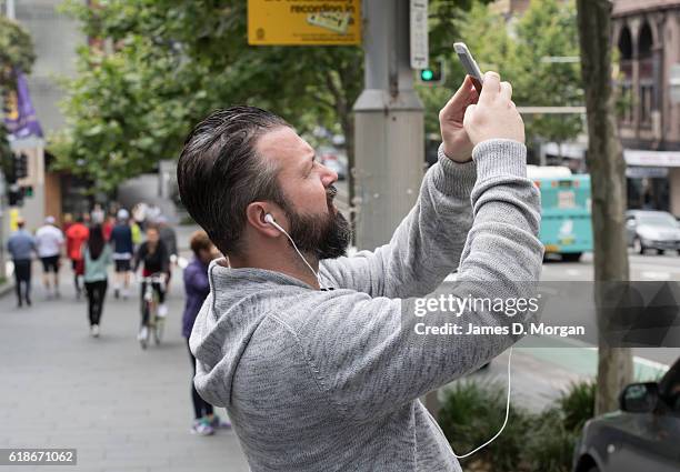 Passer by photographs an abseiling spider at the Australian Museum on October 28, 2016 in Sydney, Australia. The event was to celebrate the...