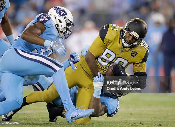 Julius Thomas of the Jacksonville Jaguars is tackled by Avery Williamson of the Tennessee Titans during the third quarter of the game at Nissan...