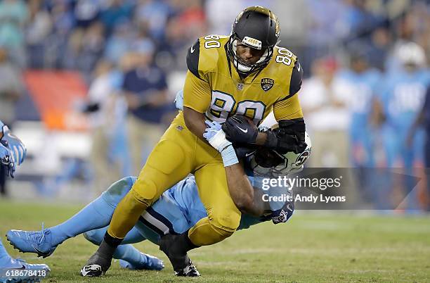 Julius Thomas of the Jacksonville Jaguars is tackled by Avery Williamson of the Tennessee Titans during the third quarter of the game at Nissan...