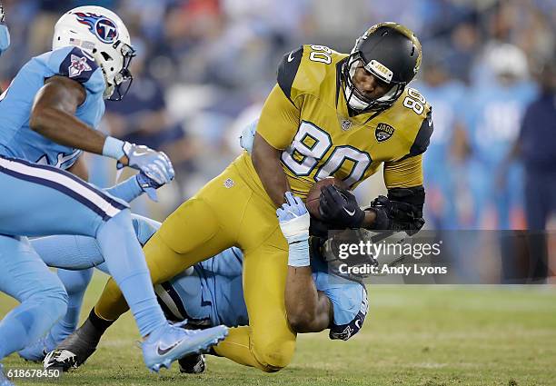 Julius Thomas of the Jacksonville Jaguars is tackled by Avery Williamson of the Tennessee Titans during the third quarter of the game at Nissan...