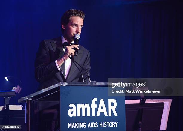 Auctioneer Alexander Gilkes speaks onstage during amfAR's Inspiration Gala Los Angeles at Milk Studios on October 27, 2016 in Hollywood, California.