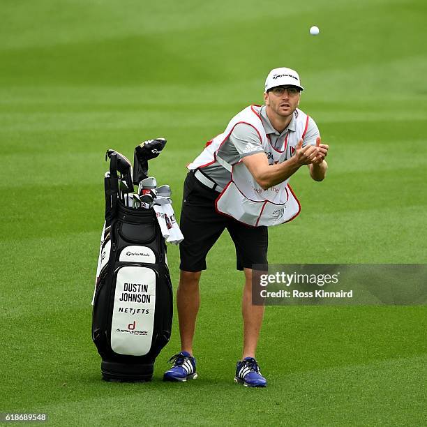 Austin Johnson, the 'HSBC Caddie of the Year' and brother of Dustin Johnson of the United States attemps to catch his players ball during the third...