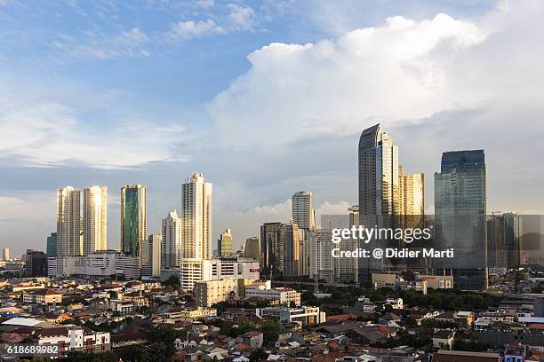 sunset over jakarta skyline - emerging markets stockfoto's en -beelden