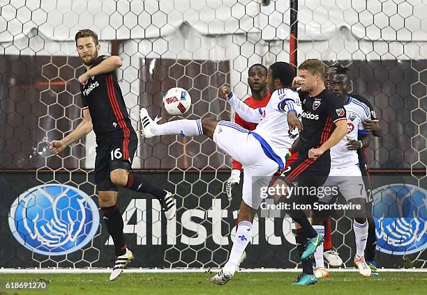 Montreal Impact midfielder Patrice Bernier blasts a shot past D.C. United forward Patrick Mullins during a MLS Cup knockout round match on October 27...