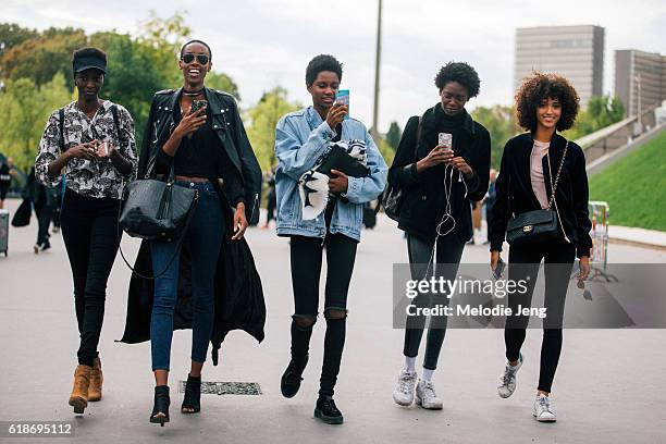 Models Tasha Moore, Tara Falla, Marie Fofana, Melodie Vaxelaire take iPhone photos after the Issey Miyake show on September 30, 2016 in Paris, France.