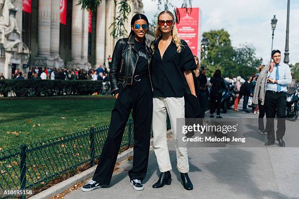 Models Imaan Hammam, Frederikke Sofie after the Mugler show at Grand Palais on October 01, 2016 in Paris, France. Imaan wears reflective sunglasses...